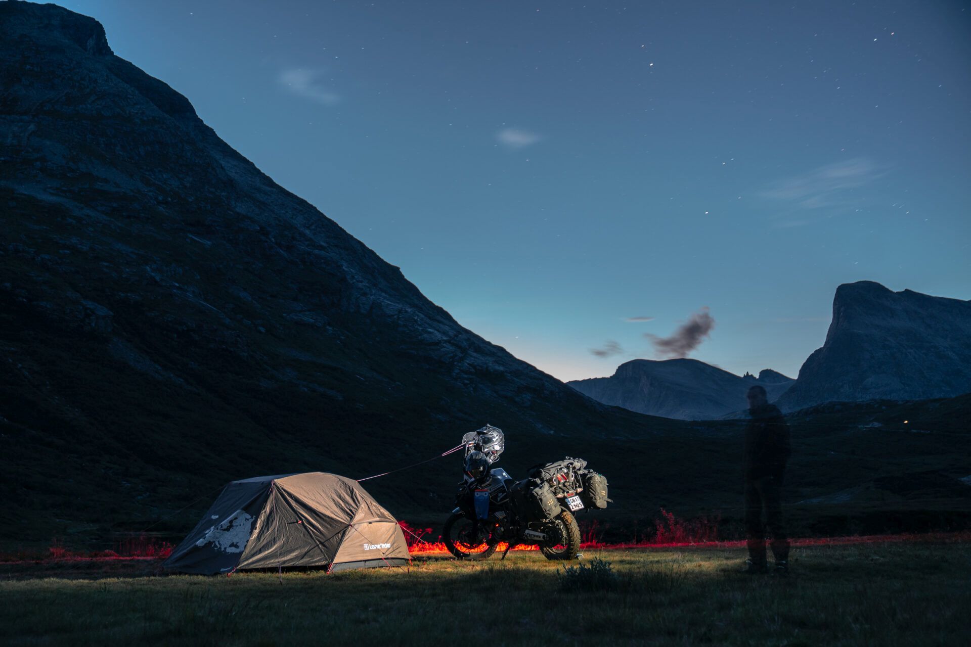 Norway night camp with tent and motorcycle